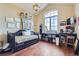 Bright bedroom with high ceilings, hardwood floors, and a large window showcasing a view at 6411 Sand Rose Ct, Castle Rock, CO 80108