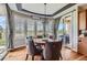 Bright dining area boasts large windows, hardwood floors, stylish light fixture and patio access at 6411 Sand Rose Ct, Castle Rock, CO 80108
