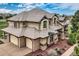 Stunning exterior of a two-story home showcases meticulous landscaping, a concrete driveway and an attached three-car garage at 6411 Sand Rose Ct, Castle Rock, CO 80108