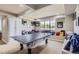 Spacious game room with a ping pong table, natural light, and window bench at 6411 Sand Rose Ct, Castle Rock, CO 80108