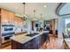 Beautiful kitchen with a large center island, hardwood floors, and open to the living room at 6411 Sand Rose Ct, Castle Rock, CO 80108