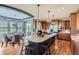 Gourmet kitchen with large island, hardwood floors, stainless steel appliances, and breakfast area at 6411 Sand Rose Ct, Castle Rock, CO 80108