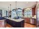 Open-concept kitchen with granite island, stainless steel appliances, and hardwood floors at 6411 Sand Rose Ct, Castle Rock, CO 80108