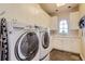 Laundry room with washer, dryer, white cabinets, and a convenient sink at 6411 Sand Rose Ct, Castle Rock, CO 80108