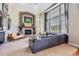 Inviting living room features a stone fireplace, large windows, and a comfortable seating area at 6411 Sand Rose Ct, Castle Rock, CO 80108