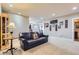 Basement living room featuring neutral walls, carpeted floor, and sports-themed wall décor at 6411 Sand Rose Ct, Castle Rock, CO 80108