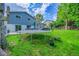Landscaped backyard featuring a deck, a trampoline, and lush greenery at 6368 S Harlan Way, Littleton, CO 80123