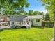 Back of house featuring a well-kept backyard with a deck, a hot tub, and outdoor seating at 6368 S Harlan Way, Littleton, CO 80123