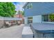 Backyard patio featuring a jacuzzi, outdoor seating, and views of the landscaped yard and mature trees at 6368 S Harlan Way, Littleton, CO 80123