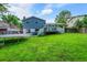 Backyard featuring a deck, manicured lawn, hot tub, and trampoline at 6368 S Harlan Way, Littleton, CO 80123
