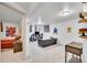 Finished basement area provides a living space with a sofa, TV, and an adjacent bedroom at 6368 S Harlan Way, Littleton, CO 80123