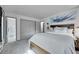 A well-lit bedroom showcases a neutral color scheme with gray carpet, a king-size bed, and ensuite bathroom access at 6368 S Harlan Way, Littleton, CO 80123