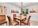 Dining area with a wooden table, upholstered chairs, chandelier, and artwork at 6368 S Harlan Way, Littleton, CO 80123