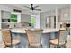 Modern kitchen featuring gray cabinets, stainless steel appliances, and a spacious granite island at 6368 S Harlan Way, Littleton, CO 80123