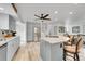 Bright kitchen with gray cabinets, a stainless steel refrigerator, and an island with bar seating at 6368 S Harlan Way, Littleton, CO 80123