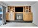Basement living room featuring a cozy fireplace, built-in shelving, and recessed lighting at 6368 S Harlan Way, Littleton, CO 80123