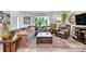 Cozy living room with a comfortable sectional sofa, a leather armchair, and light-toned laminate flooring at 6368 S Harlan Way, Littleton, CO 80123