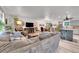 Open-concept living room and dining area with lots of natural light and modern finishes at 6368 S Harlan Way, Littleton, CO 80123