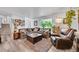 Inviting living room featuring a large sectional sofa, and a bay window with natural light at 6368 S Harlan Way, Littleton, CO 80123