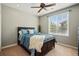 Cozy bedroom with a ceiling fan, a large window, and a comfortable bed with blue bedding at 10103 Bluffmont Ln, Lone Tree, CO 80124