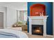 Bedroom features a fireplace with custom alcove, neutral paint and carpet, and sitting area at 10103 Bluffmont Ln, Lone Tree, CO 80124