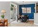 Stylish dining room with modern lighting, a bold accent wall, and a sliding door to the outdoors at 10103 Bluffmont Ln, Lone Tree, CO 80124