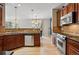 Updated kitchen with stainless steel appliances, rich wood cabinetry, and a breakfast bar overlooking the dining area at 10103 Bluffmont Ln, Lone Tree, CO 80124
