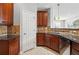 Kitchen features wood cabinets, granite countertops, stainless steel sink and backsplash at 10103 Bluffmont Ln, Lone Tree, CO 80124