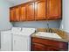 Laundry room with cabinetry above the washer and dryer; utility sink at 10103 Bluffmont Ln, Lone Tree, CO 80124