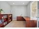Bright home office with a large desk, ample natural light, and stylish built-in shelving at 10103 Bluffmont Ln, Lone Tree, CO 80124