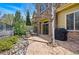 Private patio with stone pavers, BBQ, outdoor seating and stone veneer on the home's facade at 10103 Bluffmont Ln, Lone Tree, CO 80124