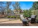 Outdoor patio with stone pavers, seating, and a view of the well-maintained landscaping and neighborhood at 10103 Bluffmont Ln, Lone Tree, CO 80124
