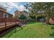 Well-maintained backyard featuring a lush lawn, wooden fence, and mature trees at 3355 Willowrun Dr, Castle Rock, CO 80109