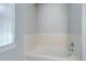 Bathroom with soaking tub next to a window with white tile at 3355 Willowrun Dr, Castle Rock, CO 80109