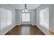 Bright dining area features hardwood floors, large windows, and a classic chandelier at 3355 Willowrun Dr, Castle Rock, CO 80109