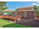 Exterior view of home featuring a wooden deck and landscaped backyard at 3355 Willowrun Dr, Castle Rock, CO 80109