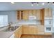 Functional kitchen features oak cabinets, white appliances, and a spacious countertop at 3355 Willowrun Dr, Castle Rock, CO 80109