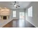 Bright living room with hardwood floors, a fireplace, and sliding glass doors to the deck at 3355 Willowrun Dr, Castle Rock, CO 80109