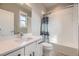 Clean bathroom featuring a tub shower, a vanity with modern sink, and ample lighting at 7010 W Alaska Dr, Lakewood, CO 80226