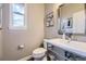 Modern half-bath with sleek fixtures, framed art and natural lighting at 7010 W Alaska Dr, Lakewood, CO 80226