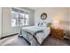 Sunlit bedroom with large window, cozy decor, carpeted floors, and a tranquil ambiance at 7010 W Alaska Dr, Lakewood, CO 80226