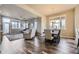 Open-concept dining area featuring hardwood floors, complemented by natural light and a view of the cozy living room at 7010 W Alaska Dr, Lakewood, CO 80226