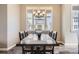 Elegant dining room with large windows, a modern chandelier, and seating for six, perfect for meals at 7010 W Alaska Dr, Lakewood, CO 80226
