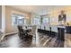 Dining area open to the kitchen featuring a large table and modern lighting fixtures at 7010 W Alaska Dr, Lakewood, CO 80226