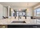 Large kitchen island with granite countertop and breakfast bar, offering views into the adjacent living and dining areas at 7010 W Alaska Dr, Lakewood, CO 80226
