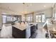 Open kitchen with a granite island, breakfast bar, and seamlessly connected to living and dining spaces, ideal for entertaining at 7010 W Alaska Dr, Lakewood, CO 80226