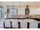 Modern kitchen featuring a granite countertop, a breakfast bar island, stainless steel appliances, and open layout at 7010 W Alaska Dr, Lakewood, CO 80226