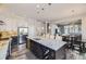 Spacious kitchen features a granite island, stainless steel appliances, and an open layout connecting to dining and living spaces at 7010 W Alaska Dr, Lakewood, CO 80226
