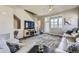 Comfortable living room featuring an entertainment center and access to the outdoors at 7010 W Alaska Dr, Lakewood, CO 80226