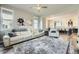 Bright living room featuring a plush sofa, large windows, and open floor plan at 7010 W Alaska Dr, Lakewood, CO 80226